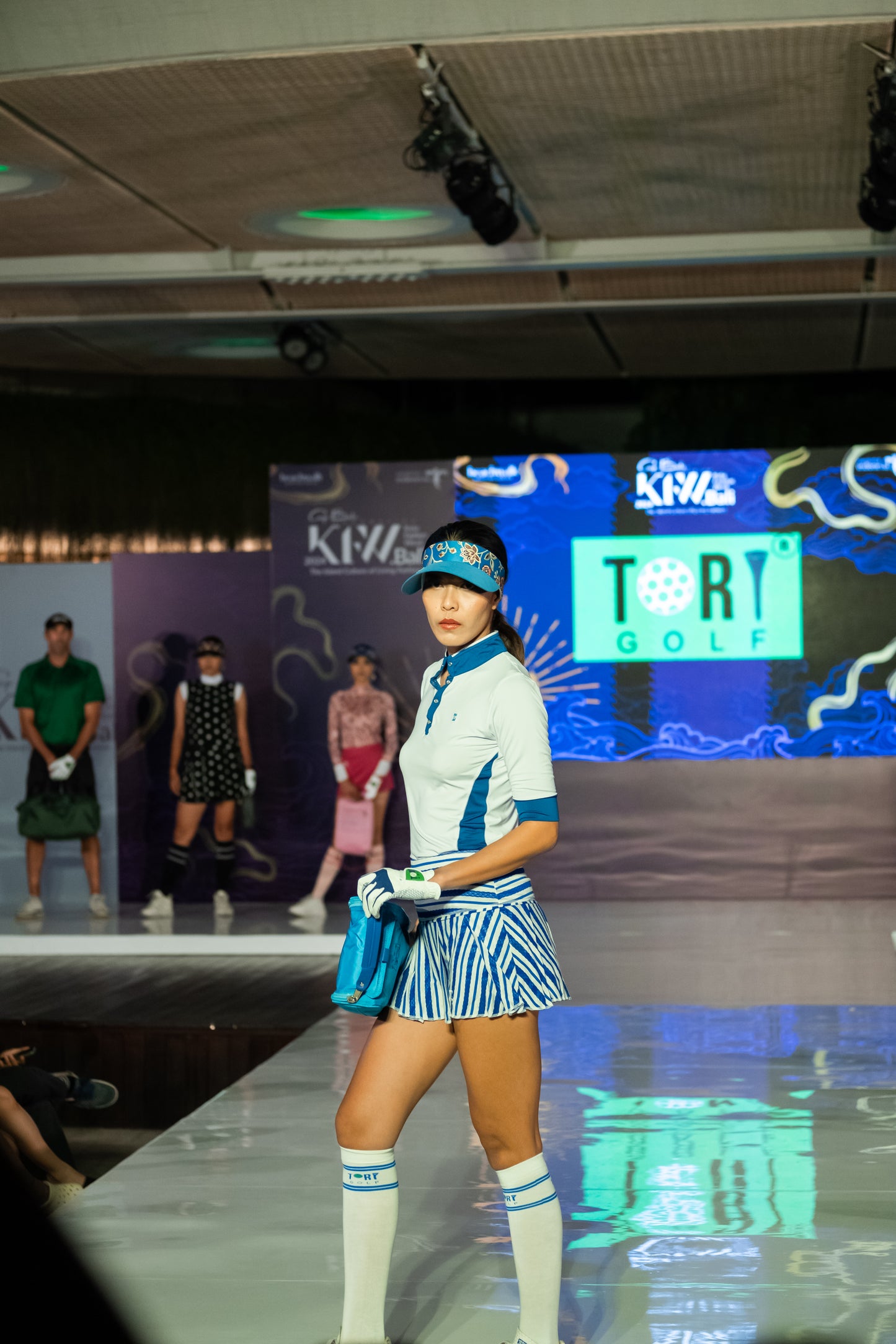 LT-129 || Ladies top white half length sleeve, mock neck snap fastened blue under arm neck and sleeve panels