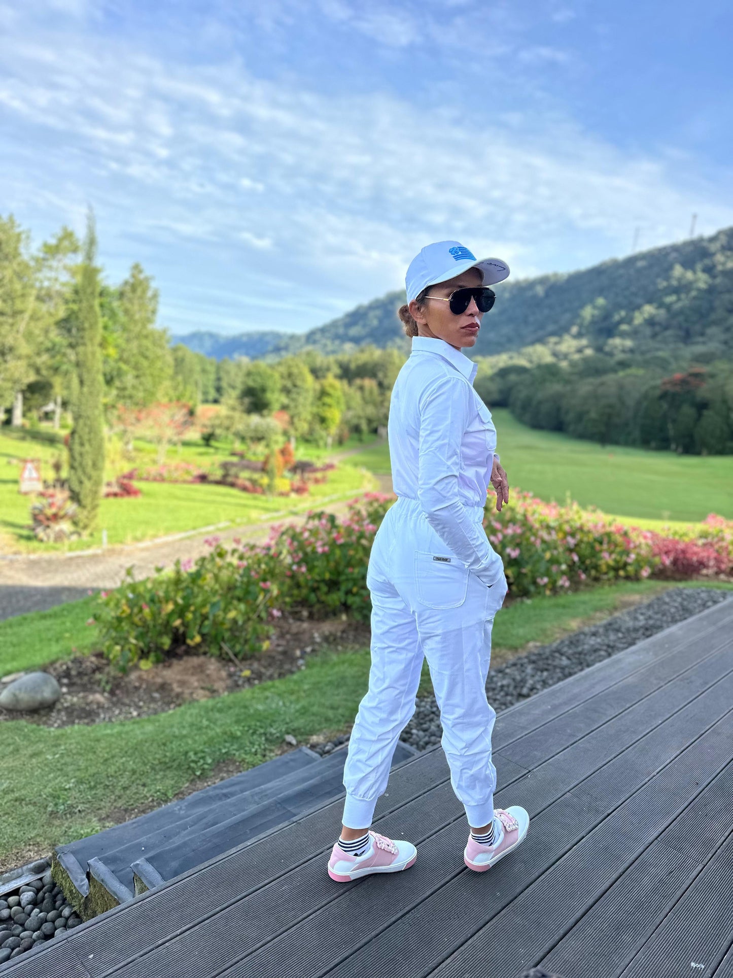 LJS-001A || Ladies Golf Jumpsuit Long Sleeve with Collar Neck White Color and Long Pants, with a Zipper in Front and 2 Pockets on The Right and Left of The Chest and Elastic Band on The Waist.