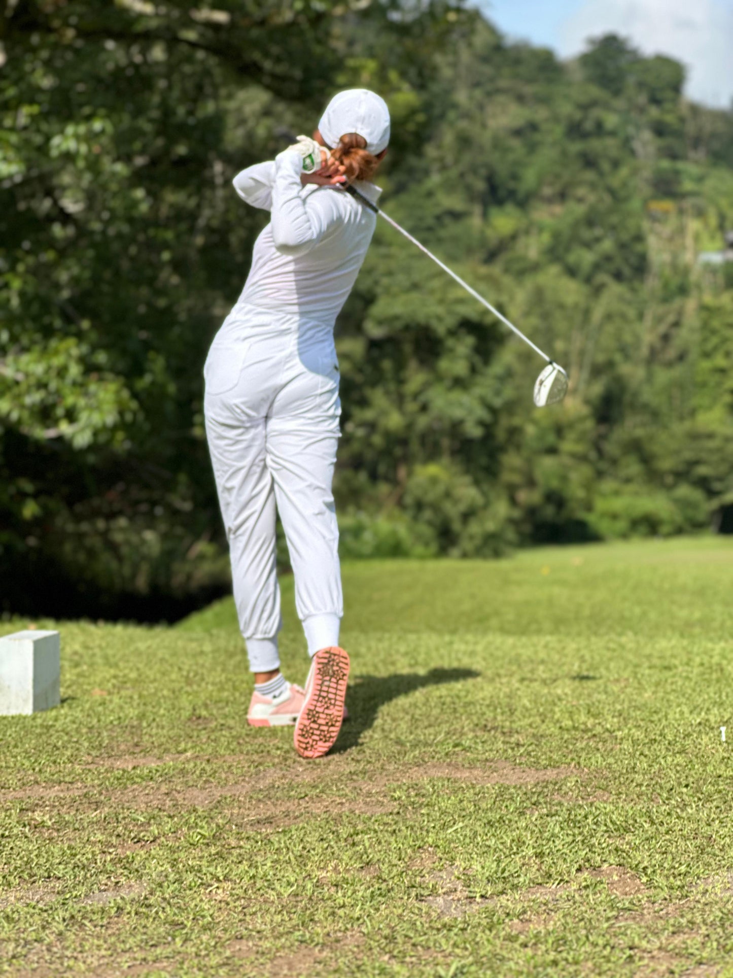 LJS-001A || Ladies Golf Jumpsuit Long Sleeve with Collar Neck White Color and Long Pants, with a Zipper in Front and 2 Pockets on The Right and Left of The Chest and Elastic Band on The Waist.