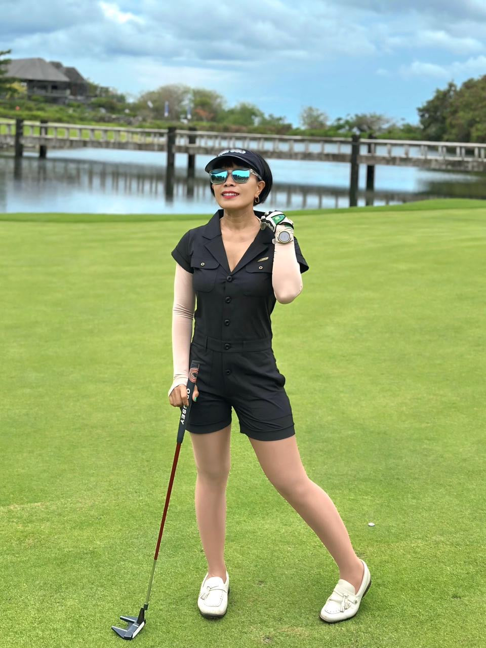 LJS-003 || Ladies Golf Jumpsuit Black Color with Shawl Sollar, Short Sleeves with Shorts and Buttons in Front and 2 Pockets on the Right and Left Sides of the Front Chest